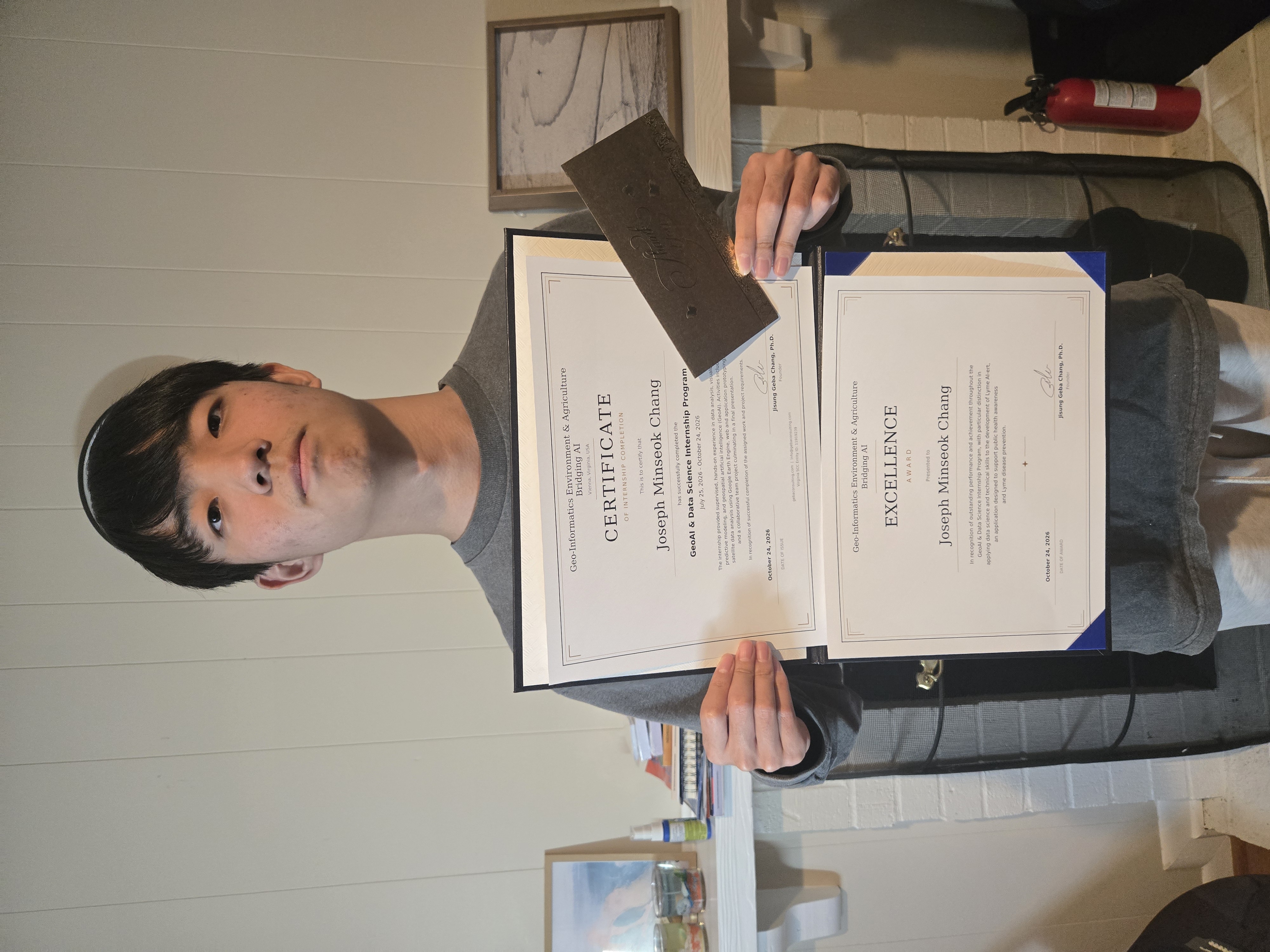 Joseph receiving internship certification and Excellence Award